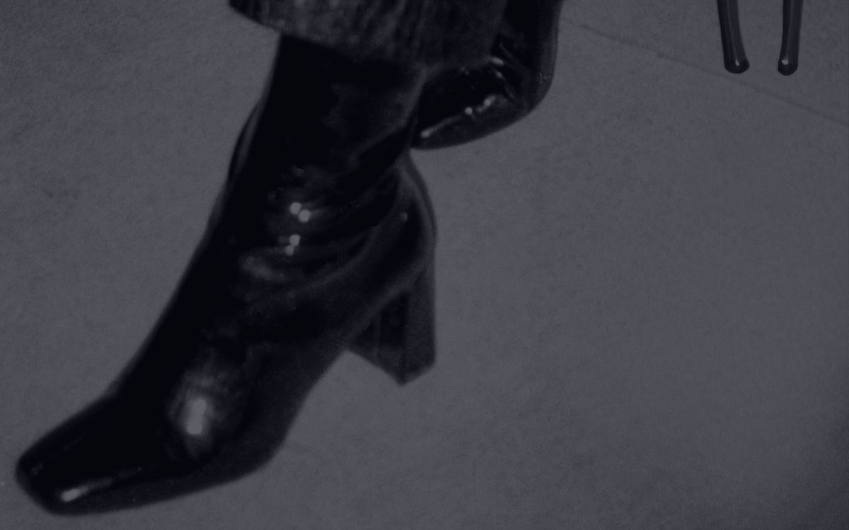 Patent leather heeled boot, black-and-white editorial still